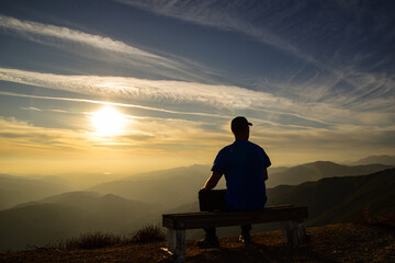 silhouette of man sitting on a bench