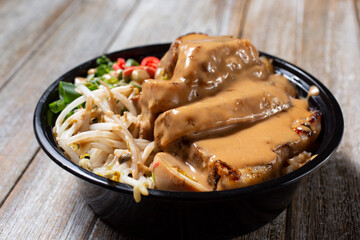 A view of a bowl of pork chashu.