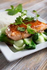 A view of a plate of honey ginger salmon with white rice.