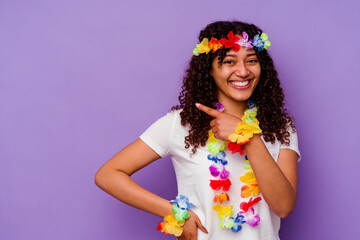 Young Hawaiian woman isolated on purple background smiling and pointing aside, showing something at blank space.