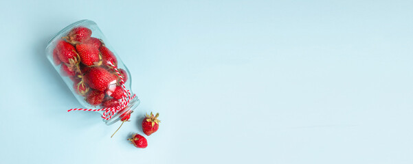 Flat lay composition of fresh strawberry berry fruits in glass bottle. Minimal composition. Flat lay, top view