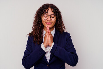 Young business mixed race woman isolated on white background holding hands in pray near mouth, feels confident.