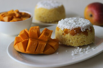 Steamed ground rice, layered with coconut shavings and mango. Locally known as Mango Puttu. A traditional healthy breakfast dish of Kerala.