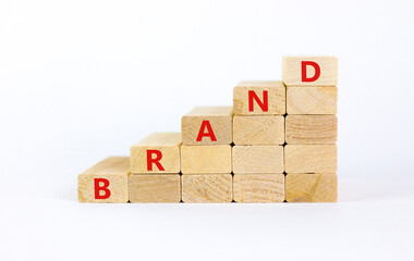Brand symbol. Concept word 'brand' on wooden cubes on a beautiful white table. White background....