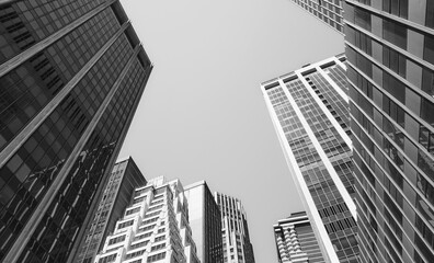 Fototapeta premium Looking up at Manhattan buildings, black and white picture, New York City, USA.