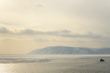 Fototapeta na wymiar Ship in the sourse of Angara from Baikal lake in winter. Listvyanka, Irkutsk Region, Russia