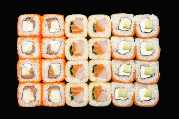 Sushi roll set with salmon, Philadelphia cheese, avocado, masago caviar, apple, perch, tobiko caviar, green onion, soy paper, unagi sauce. Isolated on black background