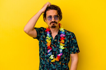 Young caucasian man wearing a hawaiian necklace isolated on yellow background being shocked, she has remembered important meeting.