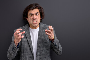 aggressive male with dark hair in panic, finds out horror news, going to cry, being in stressful...