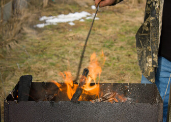 Burning firewood to get coal for the further preparation of barbecue - a national Georgian dish.