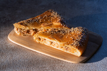 Salmon fish pie on the cutting board close up on the table.