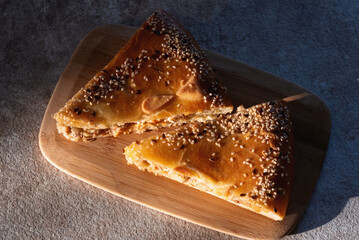 Salmon fish pie on the cutting board close up on the table.
