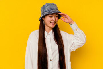 Young chinese woman isolated on yellow background joyful laughing a lot. Happiness concept.