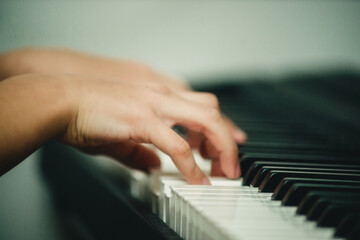 Fototapeta premium hands on the piano close-up