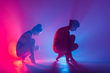 The two modern ballet dancers in black and red bodysuit, studio