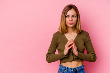 Young caucasian woman isolated on pink background making up plan in mind, setting up an idea.