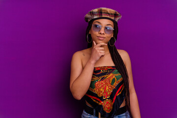 Young african american woman isolated on yellow background Young african american woman isolated on yellow background looking sideways with doubtful and skeptical expression.