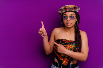 Young african american woman isolated on yellow background Young african american woman isolated on yellow background shocked pointing with index fingers to a copy space.