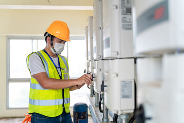 technician checking controller solar energy of the solar panels