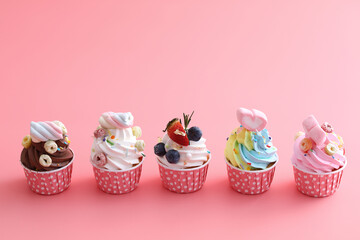 Colorful cupcakes isolated in pink background