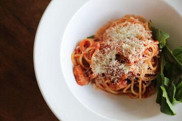 spaghetti Bolognese with italian sausage and tomato sauce with parmesan cheese and basil