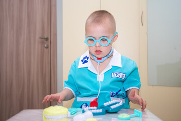 A boy with Down's syndrome plays a role-playing game, a genetically ill disabled child dressed as a...