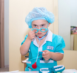A boy with Down's syndrome plays a role-playing game, a genetically ill disabled child dressed as a...