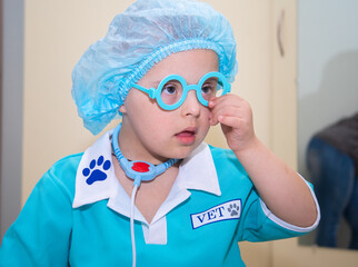 A boy with Down's syndrome plays a role-playing game, a genetically ill disabled child dressed as a...
