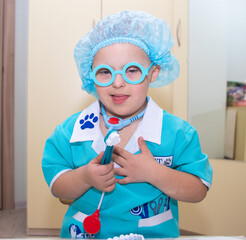 A boy with Down's syndrome plays a role-playing game, a genetically ill disabled child dressed as a...