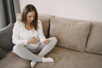 Pregnant woman looks at photo