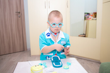 A boy with Down's syndrome plays a role-playing game, a genetically ill disabled child dressed as a...