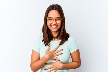 Obraz premium Young mixed race woman isolated laughs happily and has fun keeping hands on stomach.