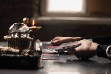 Fortune teller is reading the future with a tarot cards close up.