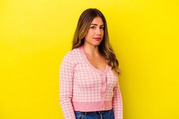 Young caucasian woman isolated on yellow background