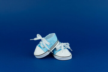 Children's shoes for a boy on a blue background. Baby shower party