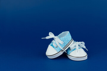 Children's shoes for a boy on a blue background. Baby shower party