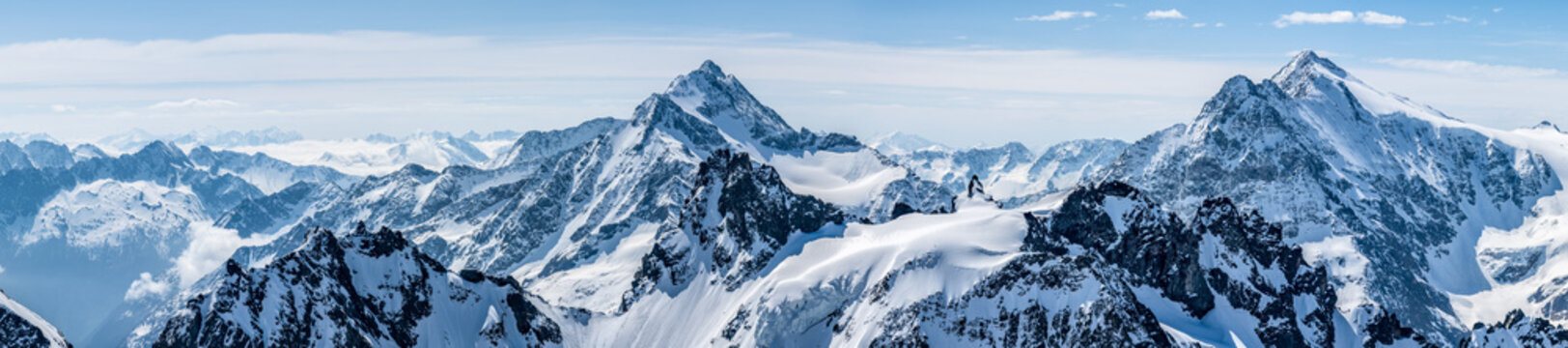 Titlis mountain. Beautiful panorama of snowy alps in white-blue tones.