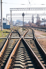 Fototapeta na wymiar Railway junction tracks in the city with track bed. Gravel and switch at a railroad crossing.