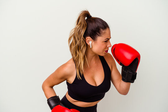 Young caucasian woman fighting with boxing gloves isolated on white background