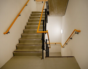 service staircase with marked steps and yellow and black handrail