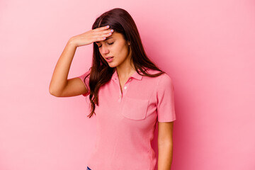 Young Indian woman isolated on pink background touching temples and having headache.