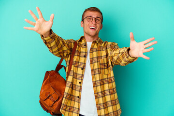 Young caucasian student man isolated on blue background