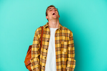 Young caucasian student man isolated on blue background
