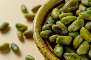 Close up of green pistachios in a bowl