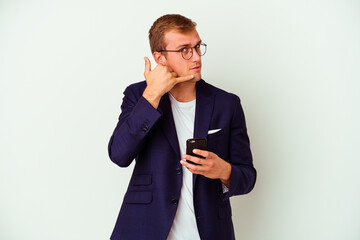 Young business man holding a phone isolated on white background