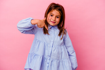 Little caucasian girl isolated on pink background  person pointing by hand to a shirt copy space,...