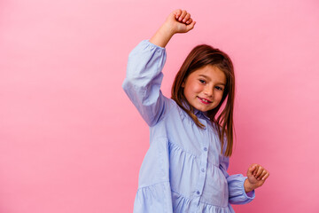 Little caucasian girl isolated on pink background  celebrating a special day, jumps and raise arms with energy.