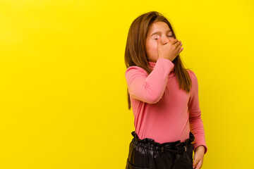 Little caucasian girl isolated on yellow background laughing happy, carefree, natural emotion.