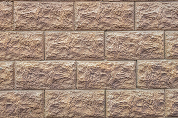 abstract background of stone lined wall painted metallic brown close up