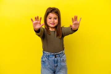 Little caucasian girl isolated on yellow background celebrating a victory or success, he is...